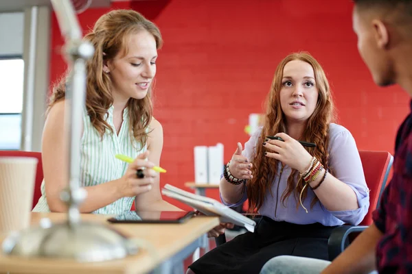 Unposed group of creative business people in an open concept office brainstorming their next project. — Stock Photo, Image