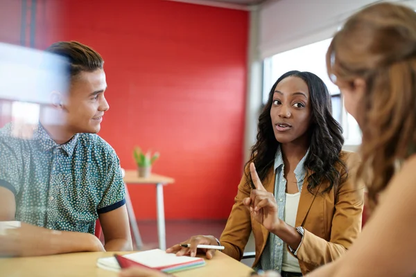 Unposed group of creative business people in an open concept office brainstorming their next project. — Stock Photo, Image