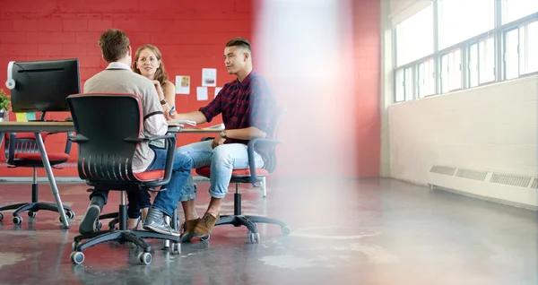 Unposed group of creative business people in a open concept office brainstorming their next project . – stockfoto