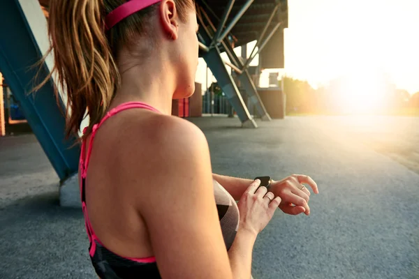 Performansı izlemek için kadın koşu mi önce onu smartwatch programlama