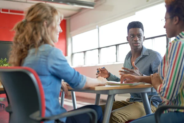 Unposed group of creative business people in an open concept office brainstorming their next project. — Stock Photo, Image