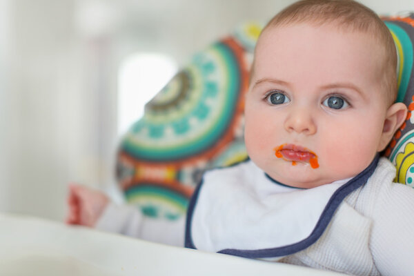 Cute baby eating puree