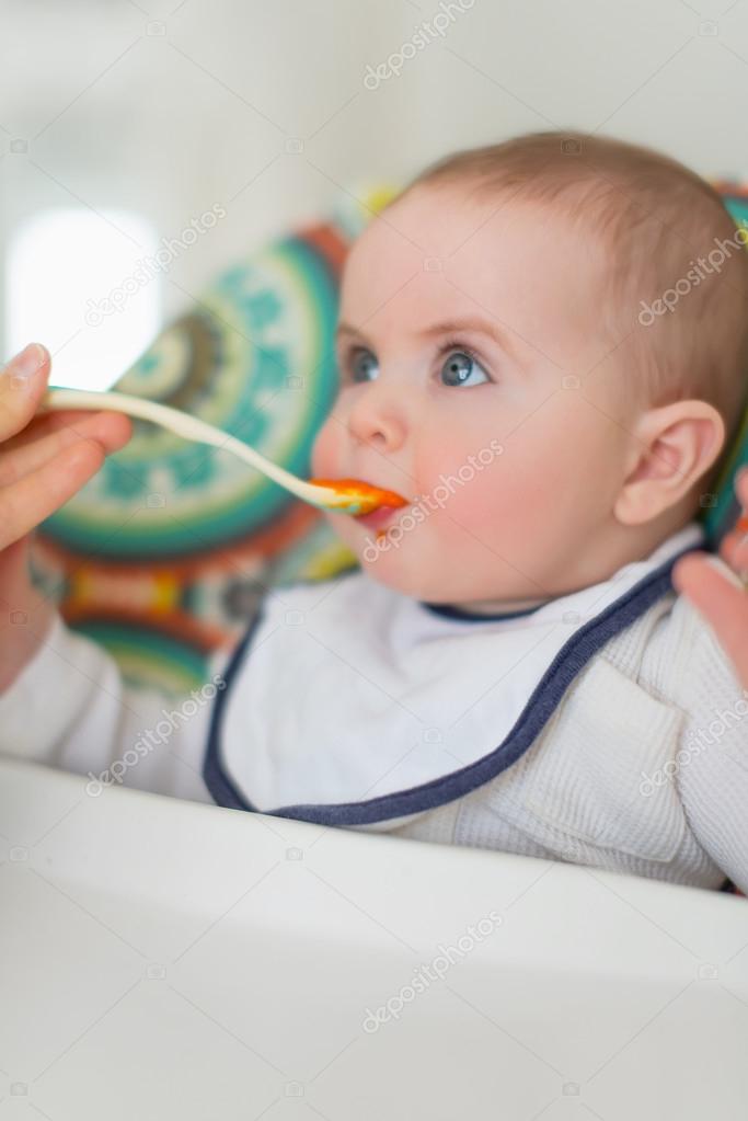 Cute baby eating puree — Stock Photo © julief514 53652391