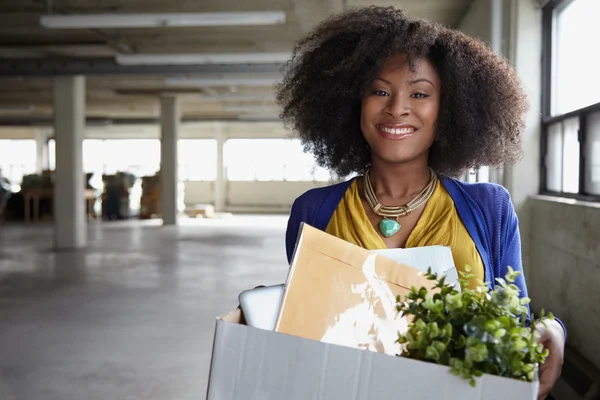 Confident businesswoman carrying a box to her new office — Stock Photo, Image