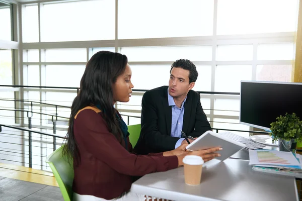 Dos colegas discutiendo ideas usando una tableta y una computadora — Foto de Stock