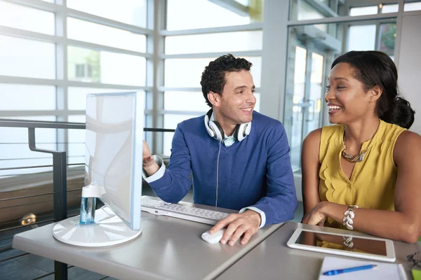 Twee collega's bespreken van ideeën met behulp van een tablet en computer — Stockfoto