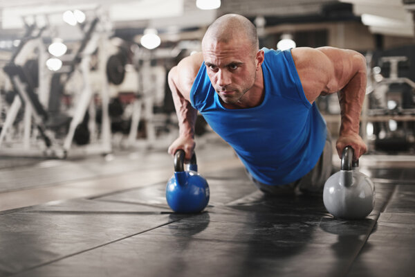 культурист работает и делает push upsat тренажерный зал в то время как
 