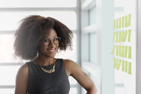 woman standing near stickers in office