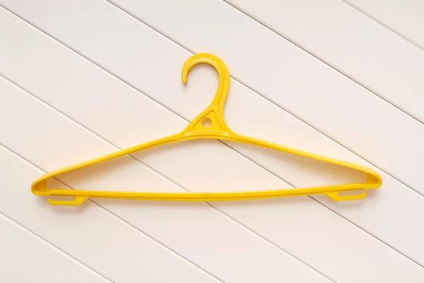 Yellow hangers for clothes — Stock Photo, Image