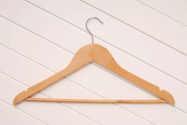 Wooden coat-hanger is on white — Stock Photo, Image