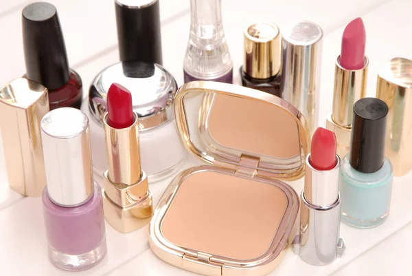 Cosmetics, lipsticks, varnish, cream are on dressing table — Stock Photo, Image