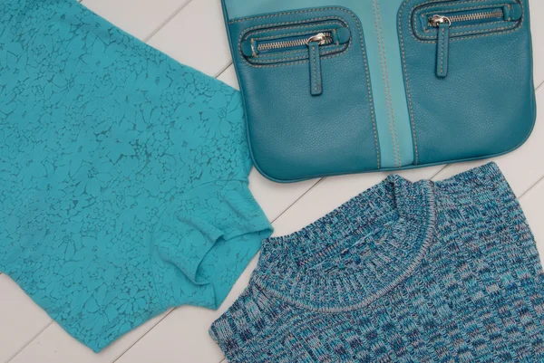 Set of turquoise clothes and flat bag — Stock Photo, Image