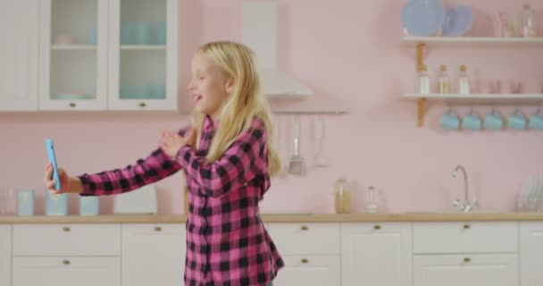 Schattig meisje opnemen video van moderne dansen voor populaire sociale netwerk. Kid maken van video voor mobiele applicatie. — Stockvideo