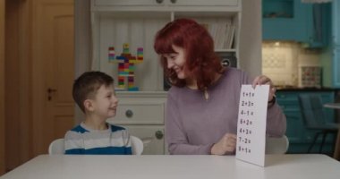 Otizm terapisti otizmli çocuklara basit matematik öğretiyor. Otizmli okul çocuğu evde annesinden öğreniyor. Otizm spektrum bozukluğu eğitimi.