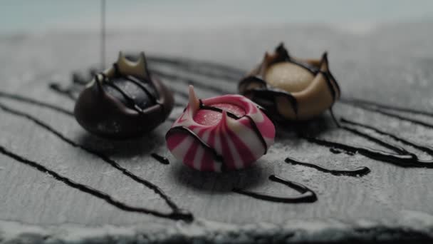 Tre färgglada godis häller av choklad topping. Matlagning dessert på slow motion. Exklusiv söt maträtt. — Stockvideo