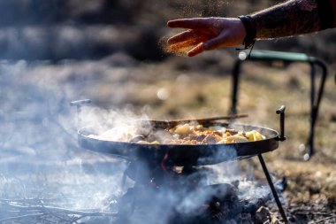 cooking in the forest park on the campfire in the pot with smoke