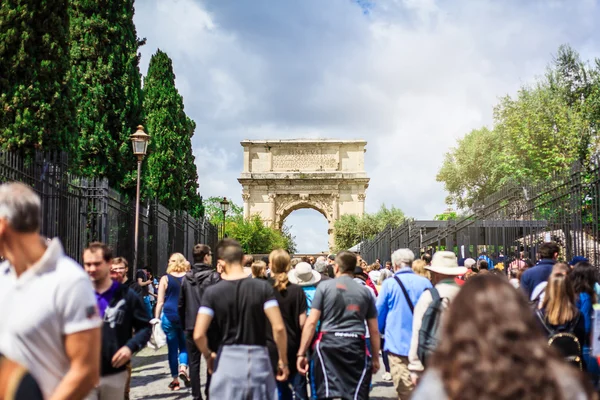 Walking by Roman Forum. Titus Arch in the background. Stock Picture