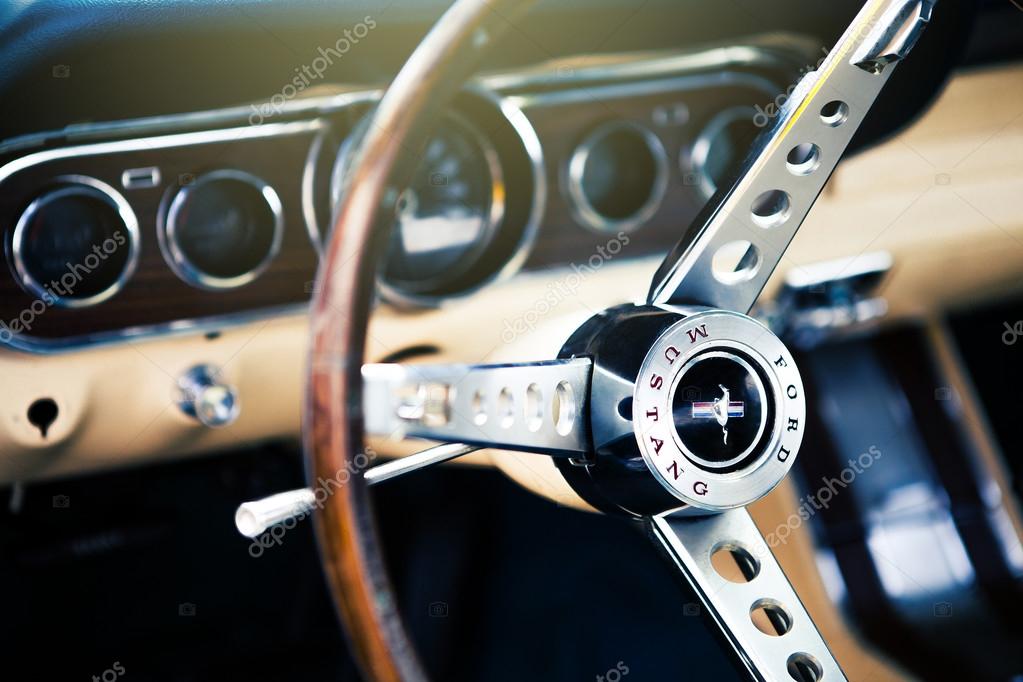 BENALMADENA, SPAIN - JUNE 21, 2015: Inside view of classic Ford Mustang, with focus on the steering wheel, in Benalmadena (Spain), on June 21, 2015.