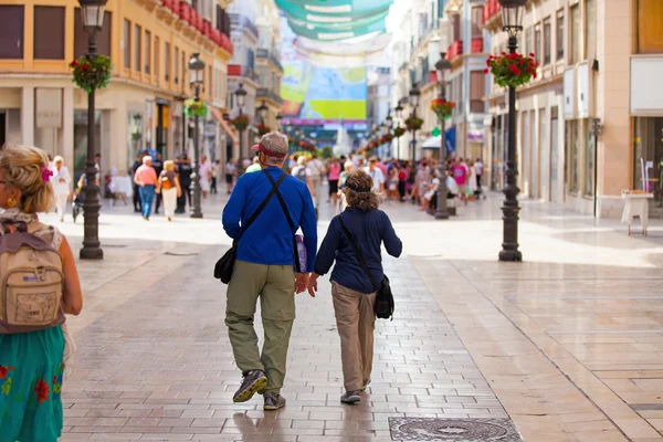 A senior couple walking at Larios street, Malaga. — Stock Photo, Image