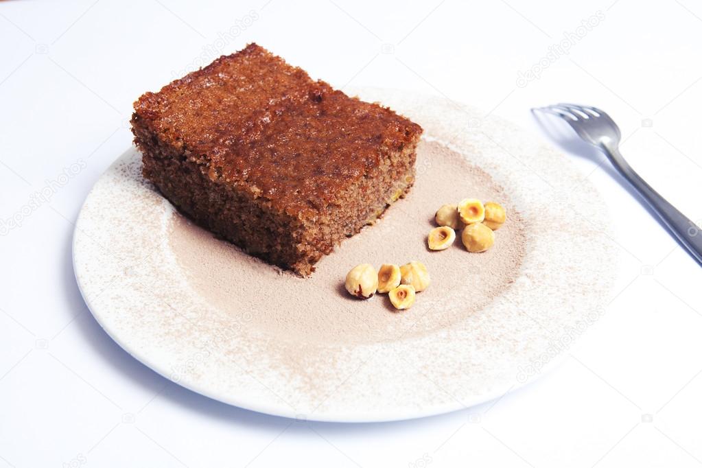 Hazelnut and chocolate sponge cake and fork.