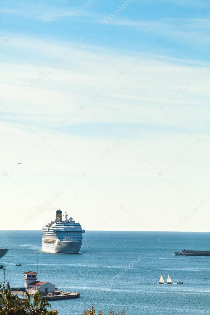 Luxury cruise ship arrivig at port.
