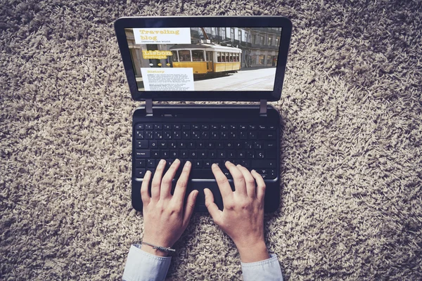 Frau tippt auf Laptop. Reiseblog auf dem Bildschirm. — Stockfoto