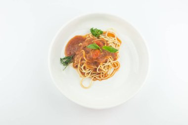 Spaghetti with tomato sauce in white plate on white background
