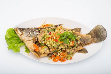 Deep Fried Sea Bass with herb and lemon grass in the white dish on white background