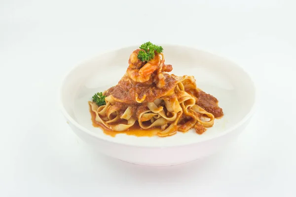 Pasta Fettuccine Bolognese with tomato sauce and prawns in white plate on white background