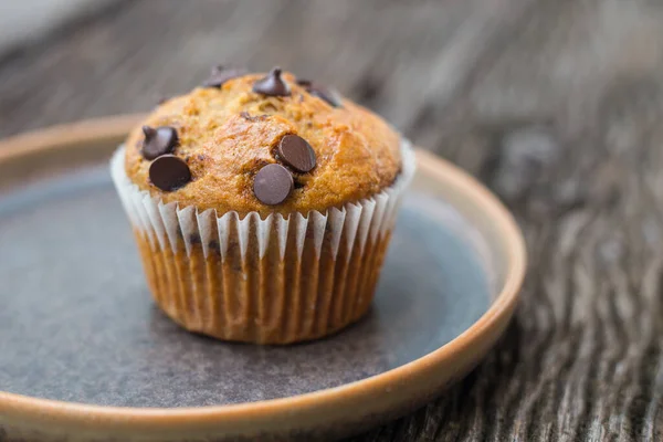 Chocolate chip muffins on wooden background