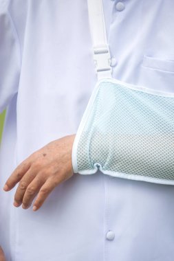 Close up old man broken arm after accident with wear arm splint