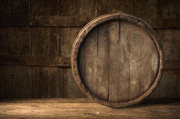 Beer barrel with glass on table wooden background