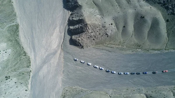 convoy of cars moving in the gobi desert top view