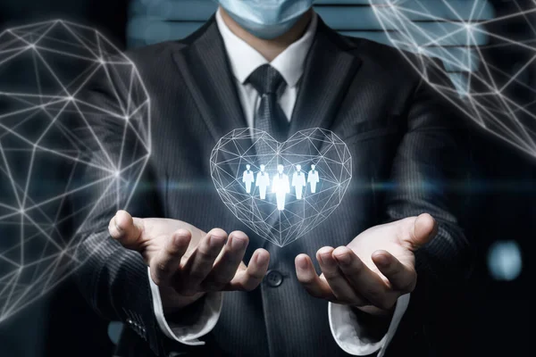 Businessman Supports Heart Which Customers Blurred Background — Stock Photo, Image