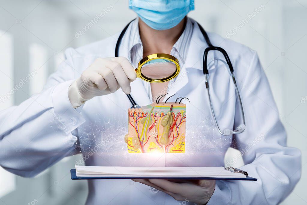 Doctor examines skin model with magnifier on blurred background.