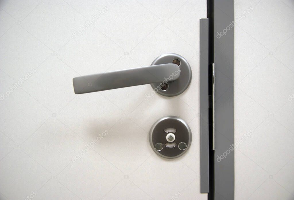 Metal handle with locks in the white door