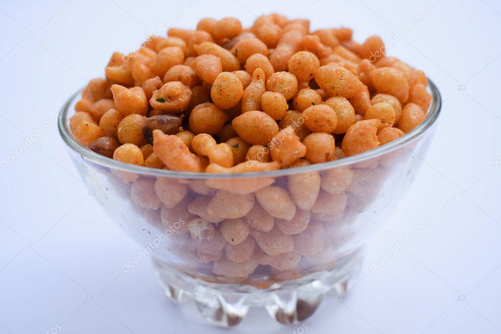 Indian famous namkeer snack Kara boondi or spicy salty boondi served in transparent bowl. Tea time snack fried chickpea floour or besan deep fried in oil. Tasty crunchy yummy homemade festival snack