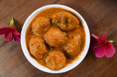 popular punjabi North Indian side dish Dum aloo with gravy. Indian food recipe baby potato vegetable eaten with rice or chapati served in bowl clipart