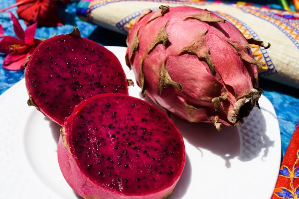 Exotic fruit called Dragon fruit, cactus pitahaya red color served with whole ripe and sliced chopped. Unique different fruit bought in india Asia