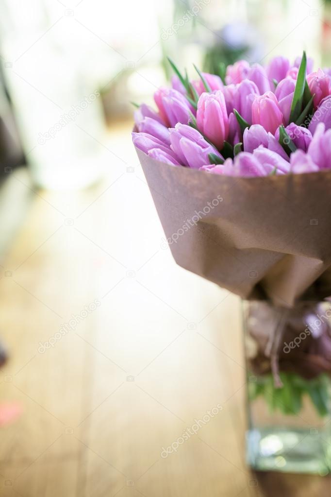 pink tulips in vase selective focus