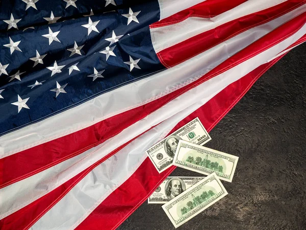 Bandera de los Estados Unidos de América y billetes de dólar. El concepto de la economía estadounidense y el comercio internacional — Foto de Stock