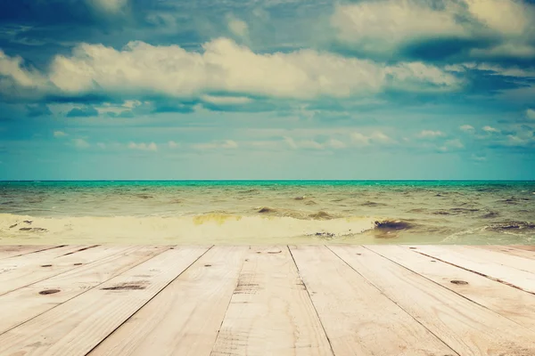 Stół z drewna i plaża morze i chmury w lato z rocznika ton. — Zdjęcie stockowe