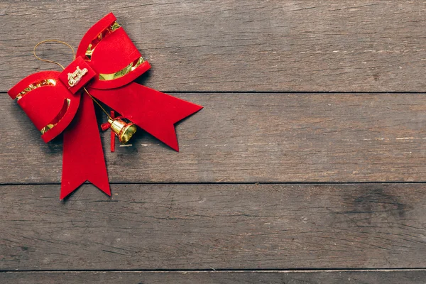 Red bow christmas on wood background with copyspace. — Stock Photo, Image