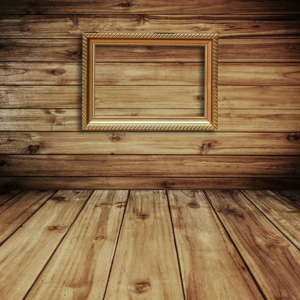 Cuadro marco dorado sobre fondo de madera — Foto de Stock