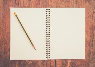 kitap ve ahşap masa üzerinde kalem