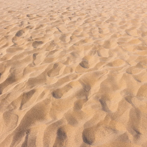 Fußspuren auf Sand und Sand Textur und Hintergrund — Stockfoto