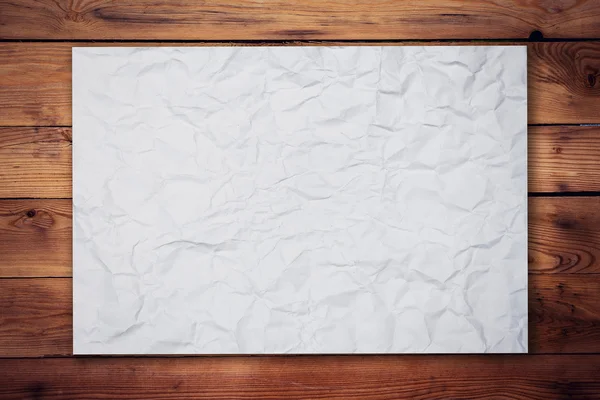 Crumpleed paper on wood background and texture — Stock Photo, Image