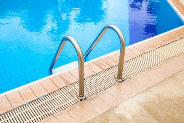 Swimming pool with stair at hotel. Royalty Free Stock Images