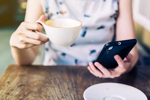 Nahaufnahme Hand Frau mit Smartphone in Café mit Tiefe o Stockbild