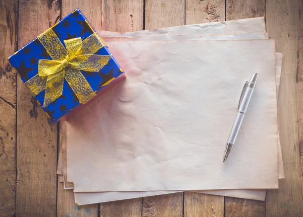 Old paper and gift box with pen for vintage background — Stock Photo, Image